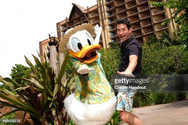 In this handout photo provided by Disney Parks, actor Jay Hayden meets Donald Duck at Aulani, a Disney Resort & Spa on May 25, 2018 Ko Olina, Hawaii.