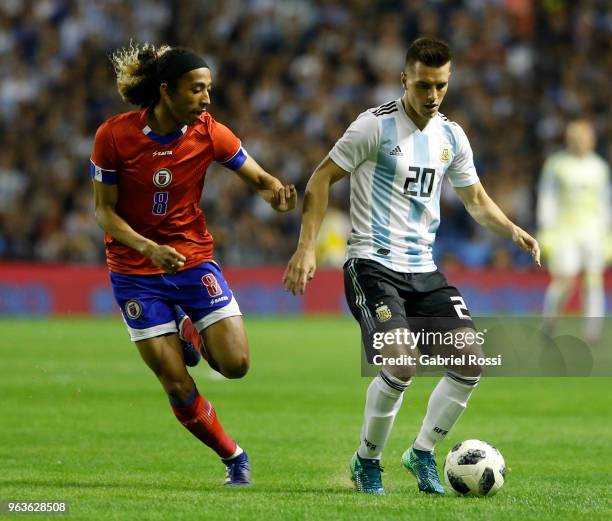 Giovanni Lo Celso of Argentina fights for the ball with Mikael Cantave of Haiti during an international friendly match between Argentina and Haiti at...