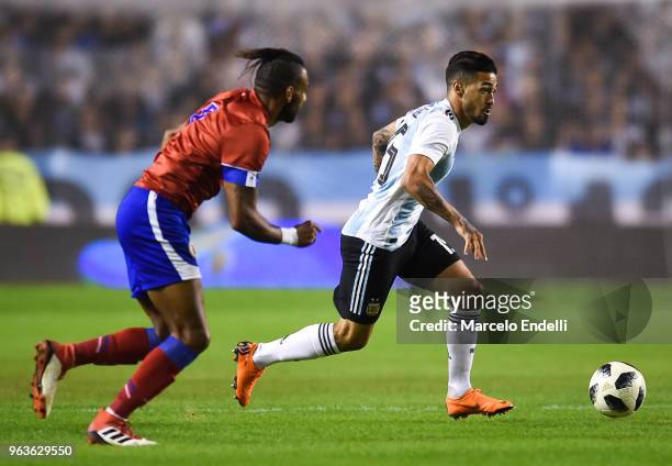 Manuel Lanzini of Argentina runs after the ball while followed by Carlens Arcus of Haiti during an international friendly match between Argentina and...