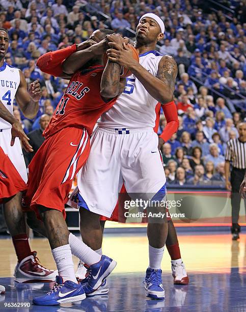 DeMarcus Cousins of the Kentucky Wildcats and Murphy Holloway of the Ole Miss Rebels battle for a rebound during the SEC game on February 2, 2010 at...