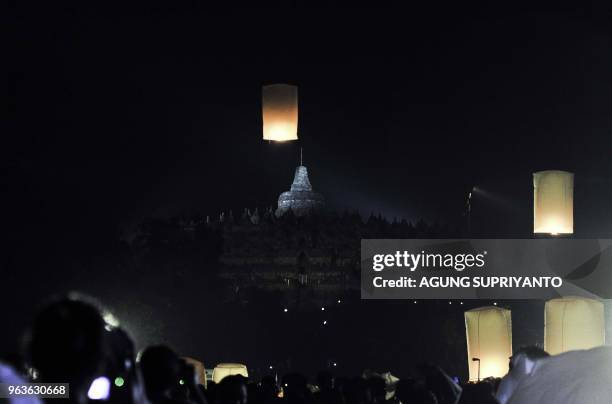 This picture taken on May 29, 2018 shows Buddhist monks and devotees releasing lanterns after conducting prayers at the Borobudur temple in Magelang,...