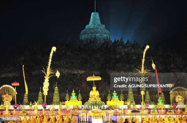 This picture taken on May 29, 2018 shows Buddhist monks conducting prayers at the Borobudur temple in Magelang, Central Java on Vesak Day. - Buddhist...