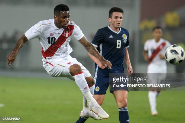 Peruvian player Jefferson Farfan vies for the ball with John McGinn of Scotland during a friendly match at the National Stadium in Lima on May 29...