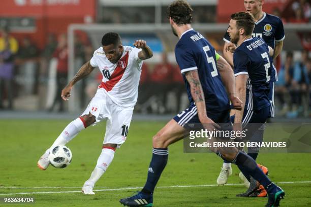 Peruvian player Jefferson Farfan vies for the ball with Charlie Mulgrew from Scotland during a friendly match at the National Stadium in Lima on May...