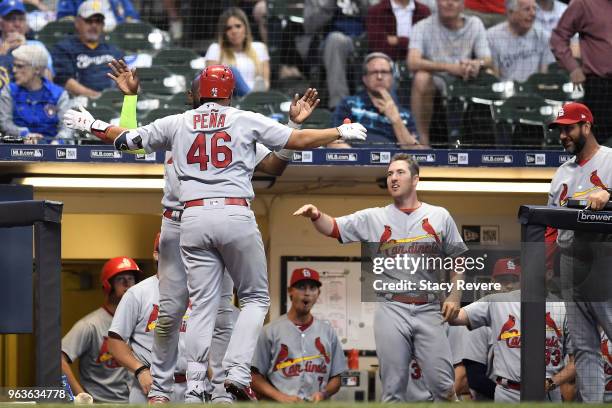 Francisco Pena of the St. Louis Cardinals is congratulated by teammates following a home run against the Milwaukee Brewers during the eighth inning...