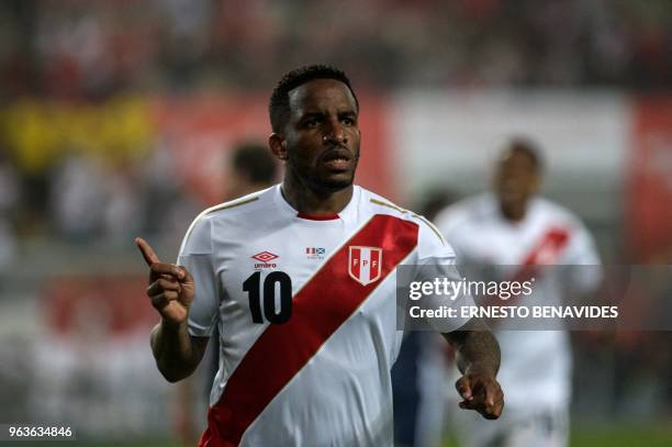 Peru's Jefferson Farfan celebrates after scoring against Scotland during a friendly match at the National Stadium in Lima on May 29 ahead of the FIFA...