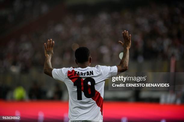 Peru's Jefferson Farfan celebrates after scoring against Scotland during a friendly match at the National Stadium in Lima on May 29 ahead of the FIFA...