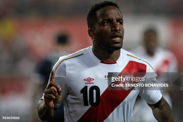 Peru's Jefferson Farfan celebrates after scoring against Scotland during a friendly match at the National Stadium in Lima on May 29 ahead of the FIFA...