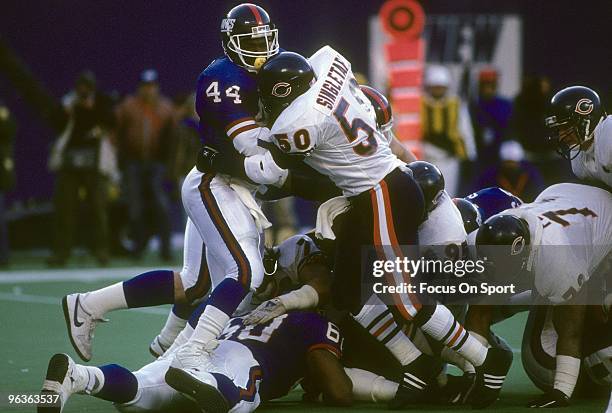 S: Middle Linebacker Mike Singletary of the Chicago Bears wraps up running back Maurice Carthon of the New York Giants during a circa late 1980's NFL...