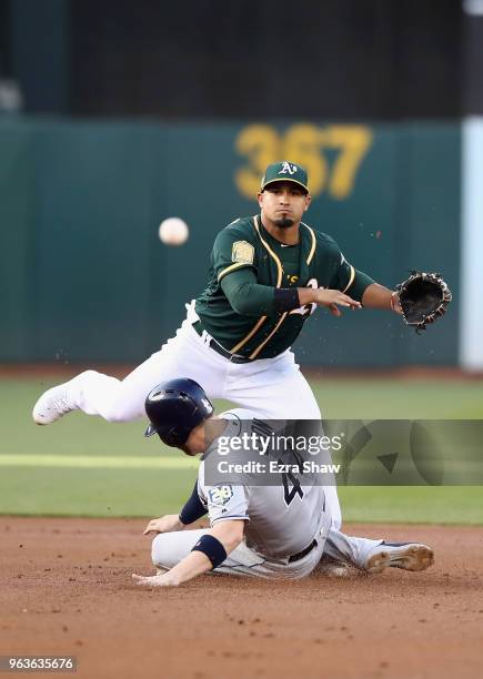 Cron of the Tampa Bay Rays breaks up a double play as Franklin Barreto of the Oakland Athletics throws to first base on ball hit by Joey Wendle of...