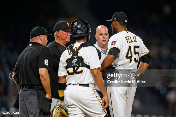 Manager Clint Hurdle of the Pittsburgh Pirates talks with pitcher Michael Feliz in the eighth inning against the Chicago Cubs at PNC Park on May 29,...