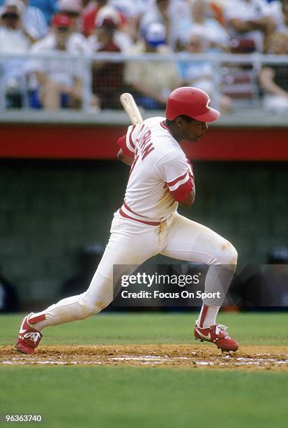 Shortstop Barry Larkin of the Cincinnati Reds swings and watches the flight of his ball during a MLB baseball game circa 1980's. Larkin played for...