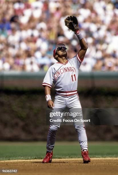 S: Shortstop Barry Larkin of the Cincinnati Reds in action against the Chicago Cubs goes tracks a pop-up on the infield during a circa early 1990's...