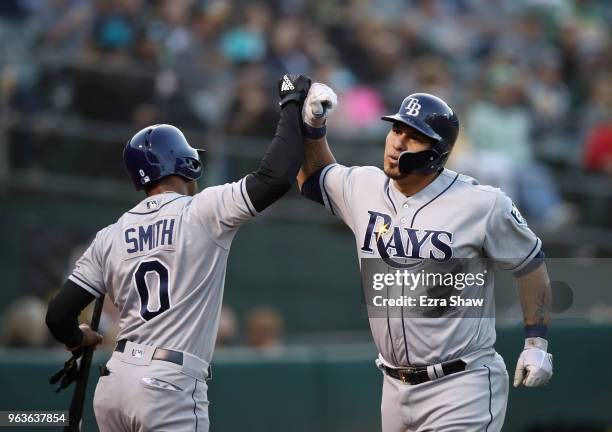 Wilson Ramos of the Tampa Bay Rays is congratulated by Mallex Smith after he hit a home run off of Daniel Gossett of the Oakland Athletics in the...