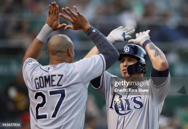 Wilson Ramos of the Tampa Bay Rays is congratulated by Carlos Gomez after he hit a home run off of Daniel Gossett of the Oakland Athletics in the...