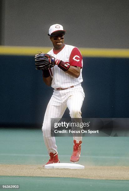 S: Shortstop Barry Larkin of the Cincinnati Reds in action sets to make a throw to first base during a MLB baseball game circa 1990's at Riverfront...
