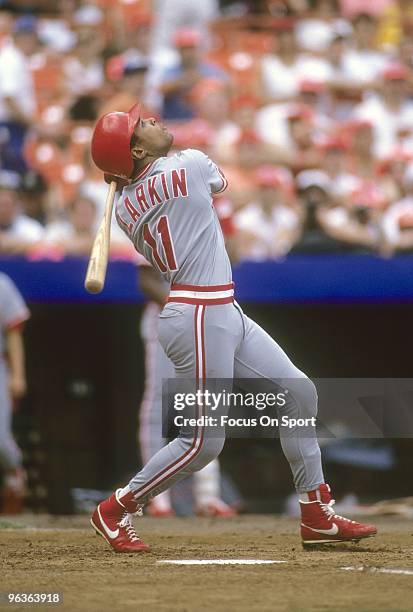 S: Shortstop Barry Larkin of the Cincinnati Reds swings and watches the flight of his ball against the New York Mets during a MLB baseball game circa...