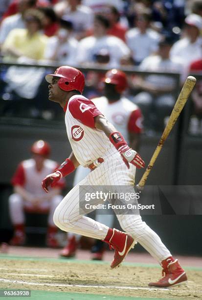 S: Shortstop Barry Larkin of the Cincinnati Reds lets the bat go watching the flight of his ball during a MLB baseball game circa 1990's at...