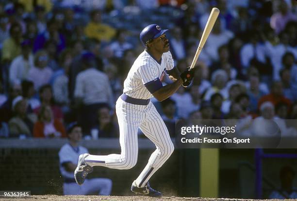 S: Outfielder Andre Dawson of the Chicago Cubs swings and watches the flight of his ball during a late circa 1980's Major League Baseball game at...