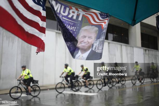 Flag featuring a picture of U.S. President Donald Trump is displayed outside a rally in Nashville, Tennessee, U.S., on Tuesday, May 29, 2018. Trump...