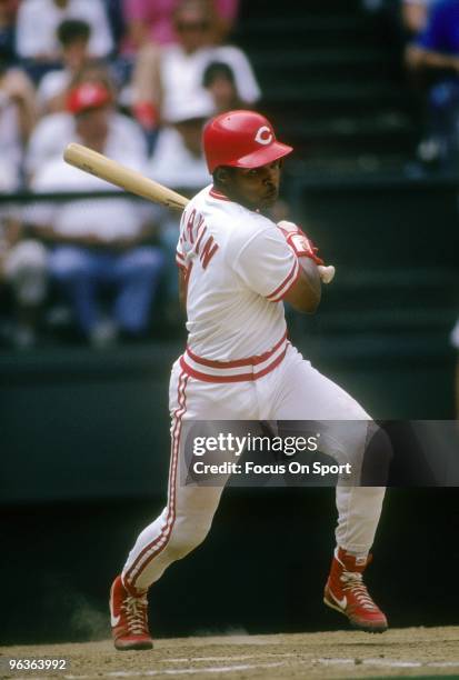 S: Shortstop Barry Larkin of the Cincinnati Reds swings and watches the flight of his ball during a MLB baseball game circa 1990's at Riverfront...