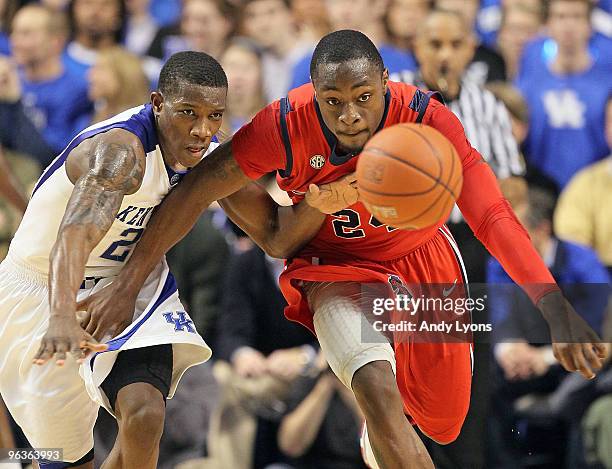 Eric Bledsoe of the Kentucky Wildcats and Terrico White of the Ole Miss Rebels reach for a loose ball during the SEC game on February 2, 2010 at Rupp...