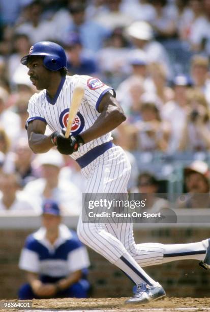 S: Outfielder Andre Dawson of the Chicago Cubs swings and watches the flight of his ball during a late circa 1980's Major League Baseball game at...