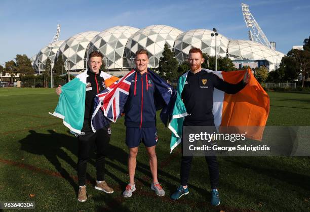 St Kilda's Ray Connellan, Qantas Wallabies superboot Reece Hodge and Hawthorn's Conor Glass pose outside AAMI park on May 30, 2018 in Melbourne,...