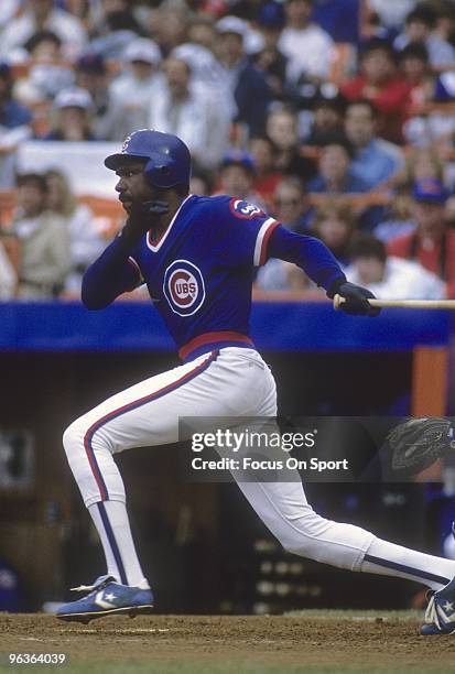 S: Outfielder Andre Dawson of the Chicago Cubs swings and watches the flight of his ball against the New York Mets during a late circa 1980's Major...