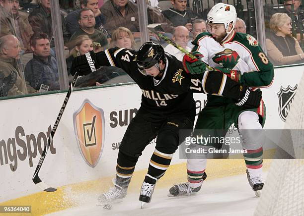 Jamie Benn of the Dallas Stars tries to keep the puck away against Brent Burns of the Minnesota Wild on February 2, 2010 at the American Airlines...
