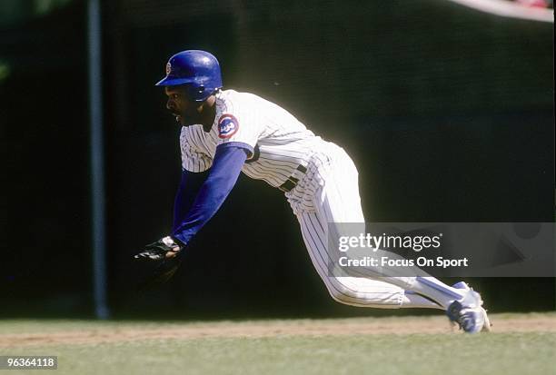 S: Outfielder Andre Dawson of the Chicago Cubs in action sliding head first into second base during a late circa 1980's Major League Baseball game at...