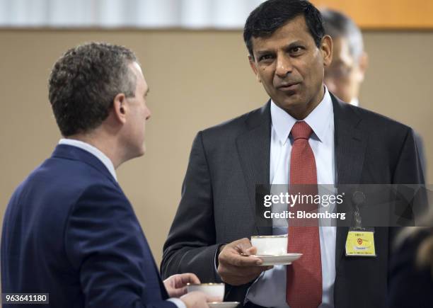 Raghuram Rajan, former governor of the Reserve Bank of India , right, speaks with James Bullard, president and chief executive officer of the Federal...