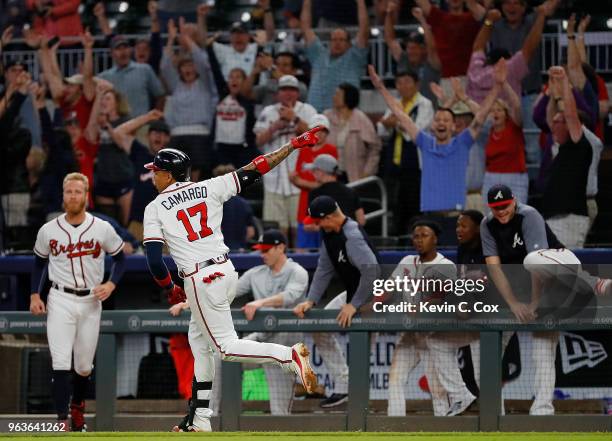 Johan Camargo of the Atlanta Braves reacts after hitting a walk-off homer in the ninth inning of a 7-6 win over the New York Mets at SunTrust Park on...