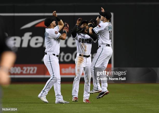 David Peralta, Jarrod Dyson and Chris Owings of the Arizona Diamondbacks celebrate a 5-2 win against the Cincinnati Reds at Chase Field on May 29,...