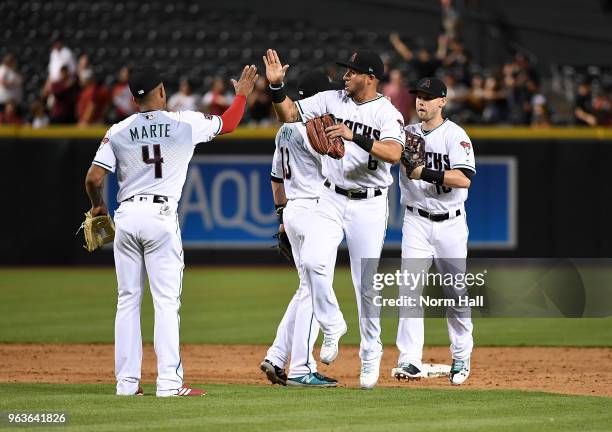 David Peralta, Ketel Marte and Chris Owings of the Arizona Diamondbacks celebrate a 5-2 win against the Cincinnati Reds at Chase Field on May 29,...