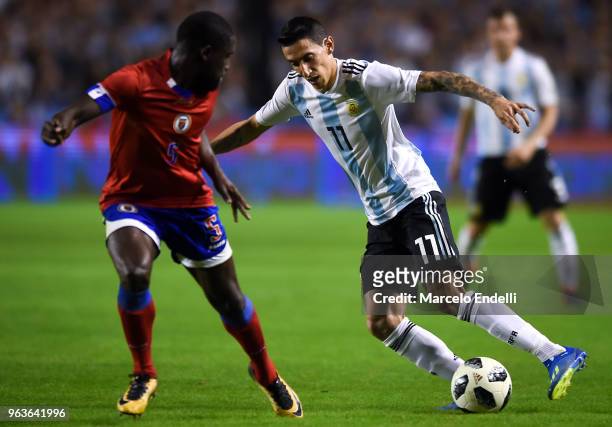 Angel Di Maria of Argentina fights for the ball with Carlens Arcus of Haiti during an international friendly match between Argentina and Haiti at...