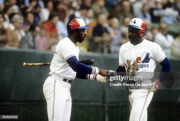 S: Outfielder Andre Dawson of the Montreal Expos after hitting a homerun shakes hands with teammate Al Oliver during a mid circa 1980's Major League...