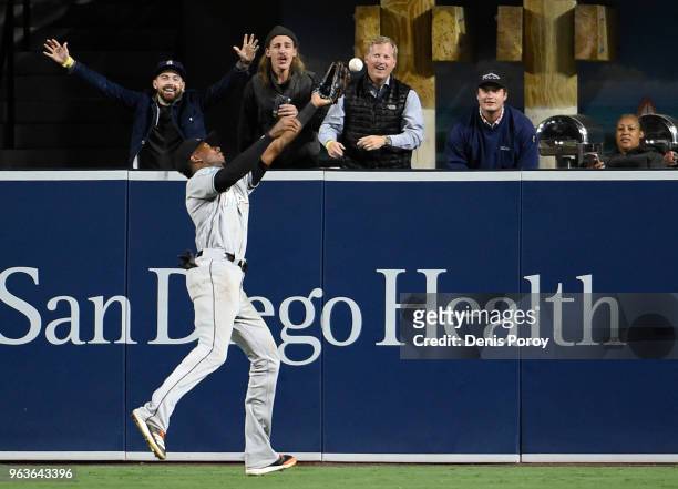 Lewis Brinson of the Miami Marlins can't make the catch on a ball hit by Freddy Galvis of the San Diego Padres during the ninth inning of a baseball...