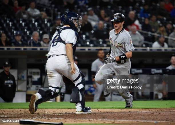 Riddle of the Miami Marlins runs as he scores ahead of the throw to Raffy Lopez of the San Diego Padres on an inside the park home run during the...