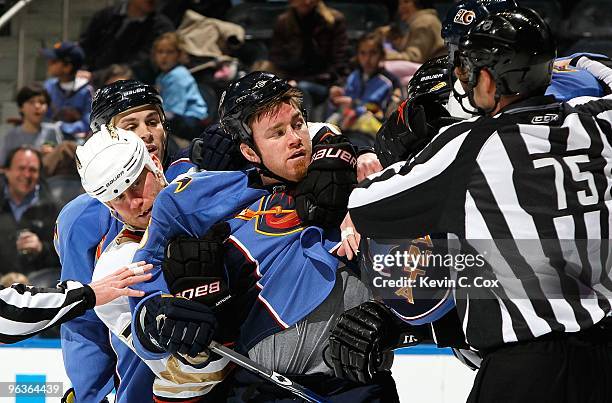 Todd Marchant of the Anaheim Ducks holds back Eric Boulton of the Atlanta Thrashers at Philips Arena on January 26, 2010 in Atlanta, Georgia.