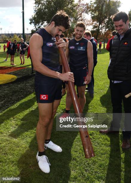 Christian Petracca of the Demons trys to play the didgeridoo after a Melbourne Demons training session at Gosch's Paddock on May 30, 2018 in...