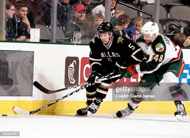 Matt Niskanen of the Dallas Stars tries to keep the puck away from Guillaume Latendresse of the Minnesota Wild on February 2, 2010 at the American...