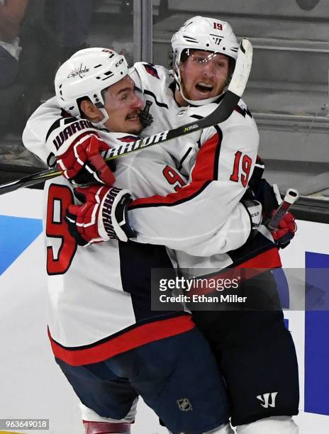 Dmitry Orlov and Nicklas Backstrom of the Washington Capitals celebrate Backstrom's first-period goal against the Vegas Golden Knights in Game One of...