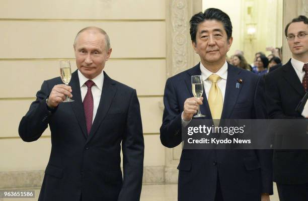 Russian President Vladimir Putin and Japanese Prime Minister Shinzo Abe raise a toast at the Bolshoi Theater in Moscow on May 26, 2018. ==Kyodo