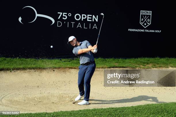 Oliver Fisher of England plays a bunker shot on the 18th hole during the Pro Am event prior to the start of the Italian Open at Gardagolf Country...