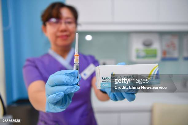 Doctor prepares to inject the 9-valent Human Papillomavirus Vaccine against cervical cancer for a woman named Shi Jiayu from Beijing at Boao Super...