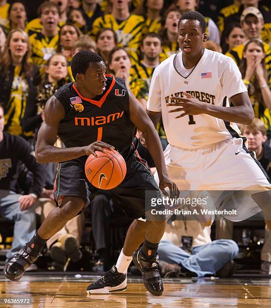 Durand Scott of the Miami Hurricanes looks for an opening while being defended by Al-Farouq Aminu of the Wake Forest Demon Deacons on February 2,...