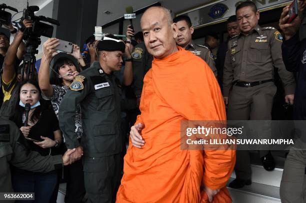 Phra Phrom Prasitthi , the abbot of Wat Saket Buddhist temple, is escorted by Royal Thai police from the Crime Suppression Division after...