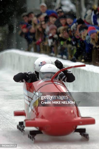 One pilot Todd Hays and teammate Pavle Jovanovic are cheered by spectators during the start of the two-man bobsleigh World Cup competition number 6...