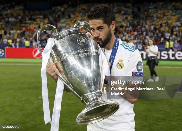 Isco of Real Madrid celebrates with The UEFA Champions League trophy following his sides victory in the UEFA Champions League Final between Real...